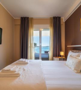 a bedroom with a large white bed with a window at Elysium Tivat in Tivat +230 photos