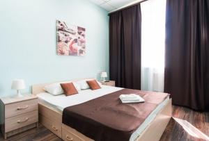 a bedroom with a large bed and a window at Гостиница Бизнес Турист in Barnaul