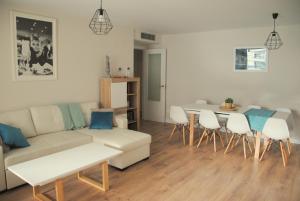 a living room with a couch and a table and chairs at Apartamento Dulcinea in Alcalá de Henares