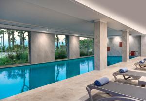 a swimming pool with blue water in a house at Radisson Collection Hotel, Bodrum in Akyarlar