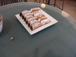 a plate of pastries sitting on top of a table at B&B Casa Valeria in Catania