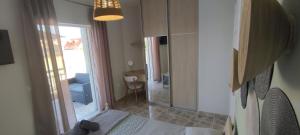 a room with a bedroom with a bed and a window at Harmony House Marathopoli 1 in Marathopoli