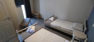 a small hospital room with a bed and a chair at Harmony House Marathopoli 1 in Marathopoli