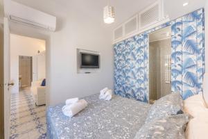 Azzurra, Capri في كابري: غرفة معيشة بها أريكة وجهاز تلفزيون