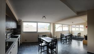 a kitchen with a table and chairs in a room at Casa Renzo in LʼAquila