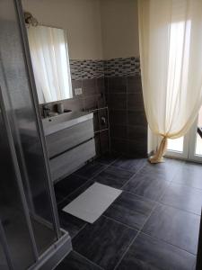 a bathroom with a shower and a sink at Casa Renzo in LʼAquila