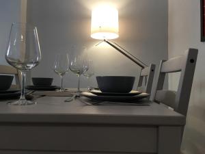 a table with wine glasses and a lamp on it at Marble Apartments Effra Court in London