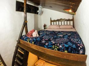 a bedroom with a bed in a room with a tripod at Ready Camp e Suítes da Cachoeira in Abraão
