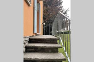 a staircase leading to a house with a gate at Appartamento a Santa Maria Maggiore in Valle Vigezzo in Santa Maria Maggiore