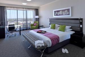 a hotel room with a bed and a television at Rydges Palmerston - Darwin in Darwin