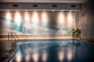 a swimming pool with a view of the water at Ośrodek wypoczynkowy Balt-Tur Feel Well Resort in Jastrzębia Góra