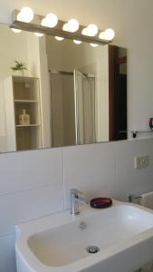 a bathroom with a sink and a large mirror at Casa Stefania Igea Marina in Bellaria-Igea Marina