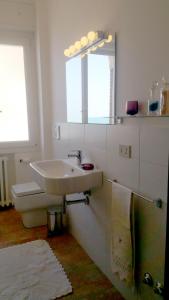 a white bathroom with a sink and a toilet at Casa Stefania Igea Marina in Bellaria-Igea Marina