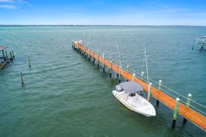 a boat is docked at a dock in the water at Avalon in Stuart +44 photos