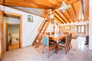 a dining room with a wooden table and chairs at C,AN ARTUR in Binissalem