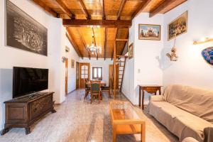 a living room with a couch and a tv at C,AN ARTUR in Binissalem