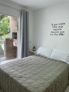um quarto com uma cama grande e uma janela em Paraíso na Ilha da Gigóia no Rio de Janeiro