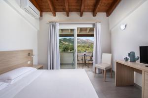 a bedroom with a bed and a view of a table at Hotel San Teodoro in San Teodoro