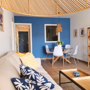 een woonkamer met een witte bank en een blauwe muur bij LA CASA AZUL in Altea