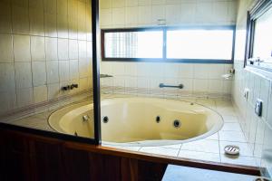 a bath tub in a bathroom with a window at Casa Cerro Dorado vista al lago in San Carlos de Bariloche +39 photos