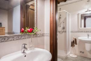 a bathroom with a sink and a toilet and a mirror at Casale Eclissi in Bagnaia +20 photos