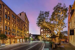 an empty city street at night with buildings at Sydney Harbour Hotel in Sydney