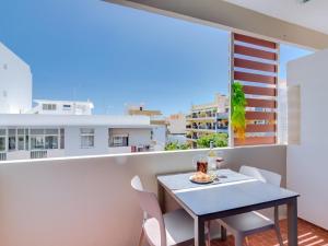 a table and chairs on the balcony of a apartment at AL - Apartamento Miratlântico in Quarteira