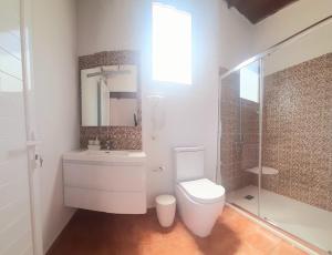 a bathroom with a toilet and a sink and a shower at Vista al Mar in Frontera