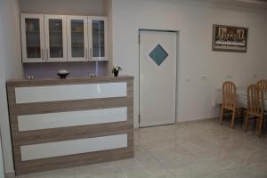 a kitchen and dining room with a table and chairs at Pansion Milena in Međugorje