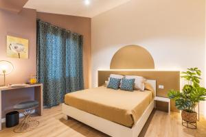 a bedroom with a bed with blue curtains at Thalassos rooms in Su Forti