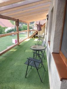 a patio with chairs and tables on a porch at Zemianska Kúria Vachtár in Kráľová Lehota +80 photos