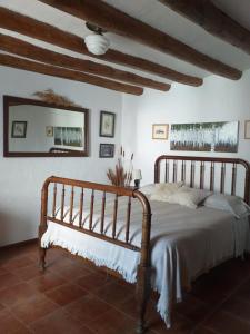a bedroom with a bed and a mirror in a room at Casa Rural Boletas in Loporzano