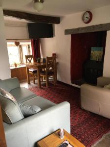 a living room with a couch and a table at Sweetbriar Cottage Bed & Breakfast and Camping in Starbotton