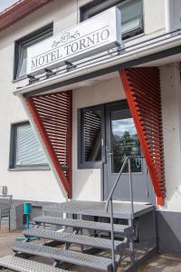 a front door of a motel room with a sign on it at Motel Tornio in Tornio