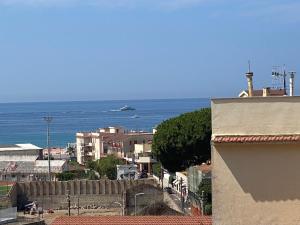a view of the ocean with a boat in the water at Residenza Baffra in Gaeta