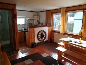 a kitchen with a wheel in the middle of a room at Casa Riciu in Buşteni