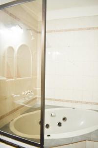 a bath tub in a bathroom with a glass door at Casa Cerro Dorado vista al lago in San Carlos de Bariloche