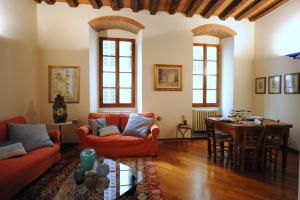 a living room with orange furniture and a table at Acacia Firenze - Quercia in Florence