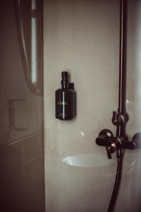 a soap dispenser on the wall of a shower at Babel Belleville in Paris