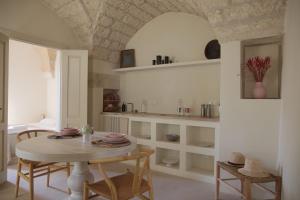 a kitchen with a table and chairs in a room at Lanime - Bed in Spa in Sogliano Cavour