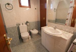 a bathroom with a toilet and a sink at Casa Placet de Sant Joan Apto in Morella +36 photos