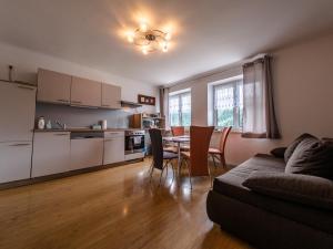 a living room with a couch and a table with chairs at Eisenerz Stefan Apartment / Ferien Wohnung in Eisenerz