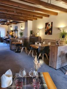 a restaurant with tables and chairs in a room at Maison de Laveline in Laveline