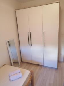 a room with two white cabinets and a table at Salona Croatia in Solin