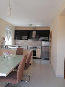 a large kitchen with a table and chairs in it at Salona Croatia in Solin +19 photos