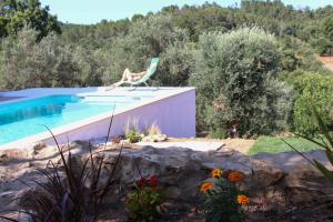 a chair sitting next to a swimming pool at Lameira Da Longra - Wellness Retreat in Tomar