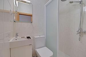 a bathroom with a toilet and a sink and a shower at Quarteira Beach & Ocean View by Homing in Quarteira +16 photos