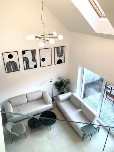 a living room with a couch and a glass table at Prázdninový dům Mikulov in Mikulov