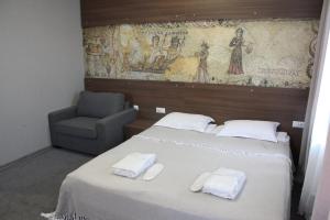 Postel nebo postele na pokoji v ubytování Hotel History • სასტუმრო ისტორია