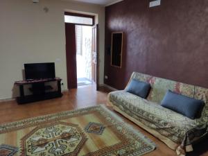 a living room with a couch and a television at casa PaMelia in Frosinone
